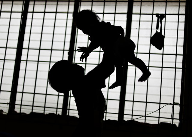 Children play inside a school classroom turned into a temporary evacuation center in Cavite city, Philippines, 23 July 2024. Fatalities due to Typhoon Gaemi have increased to eight in Mindanao island and close to a hundred families fled their homes in Cagayan province, the National Disaster Risk Reduction and Management Council (NDRRMC) reported on 23 July. Tropical cyclone wind signal (TCWS) Number Two was hoisted over several areas in Batanes as Typhoon Gaemi gustiness intensified, the weather bureau said. (Photo by Francis R. Malasig/EPA)