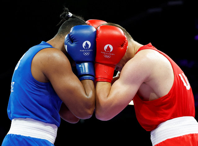 Lopez Cardona of Cuba and Oleksandr Khyzhniak of Ukraine appear inseparable in the 80kg semi-final on August 4, 2024, but it was Khyzhniak who progressed to the final. (Photo by Peter Cziborra/Reuters)