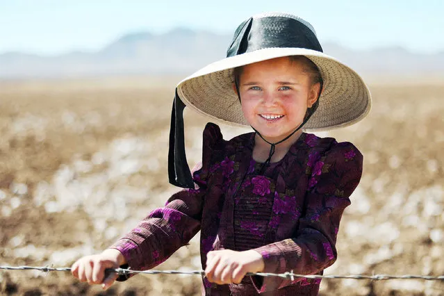 Mennonite Katharina Herder, 6, poses for a picture at the Mennonite village of Sabinal in Chihuahua state, Mexico, on March 5, 2022. A hundred years after their arrival in the north of Mexico, the Mennonite community debates between those who keep their ancient traditions and those who embrace modernity, as electricity and internet, including a TikToker youngster. (Photo by Herika Martinez/AFP Photo)