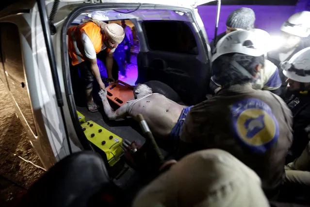 Civil defence members carry an injured man into an ambulance after Russian air strikes on the Syrian rebel-held city of Idlib, Syria, early May 31, 2016. (Photo by Khalil Ashawi/Reuters)