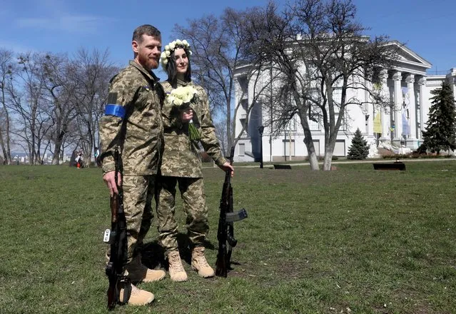 Members of the Ukrainian Territorial Defence Forces Anastasiia (24) and Viacheslav (43) attend their wedding ceremony, amid Russia's invasion of Ukraine, in Kyiv, Ukraine, April 7, 2022. (Photo by Mykola Tymchenko/Reuters)