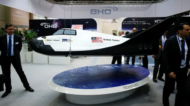Visitors watch the Dream Chaser Cargo System developed by Sierra Nevada Corporation (SNC) Space Systems at the ILA Berlin Air Show in Schoenefeld, south of Berlin, Germany, June 1, 2016. (Photo by Fabrizio Bensch/Reuters)