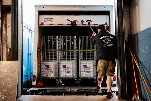 A worker closes a truck holding election equipment and supplies to be distributed to polling locations in Bucks County at a warehouse on October 29, 2024 in Doylestown, Pennsylvania. According to Deputy Director of Communications for Bucks County Jim O'Malley, county employees work with a shipping vendor over several days to move supplies and equipment in place at Bucks County's 304 voting precincts where the supplies remain locked until accessed by poll workers on Election Day. (Photo by Hannah Beier/Getty Images)