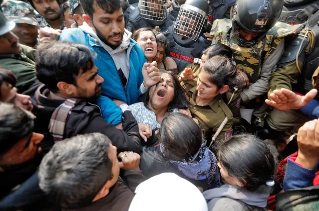 Demonstrators scuffle with police as they try to cross barricades during a protest against a new citizenship law outside the Jamia Millia Islamia university in New Delhi, India, February 10, 2020. (Photo by Adnan Abidi/Reuters)
