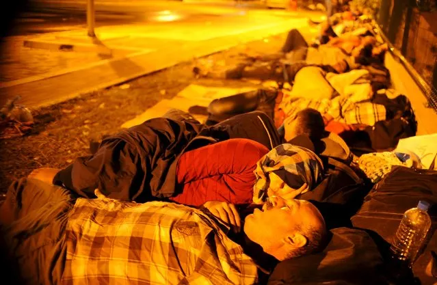 Immigrants sleep at Gevgelija railway station, Macedonia August 19, 2015. (Photo by Ognen Teofilovski/Reuters)