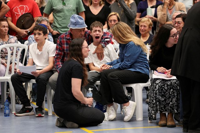 Itamar Weinstein, the son of Israeli farmer Omer Weinstein, cries during his father's funeral, after Weinstein was killed yesterday following an attack from Lebanon over its border towards northern Israel, amid ongoing hostilities between Hezbollah and Israel, in Rosh Pina, Israel on November 1, 2024. (Photo by Violeta Santos Moura/Reuters)