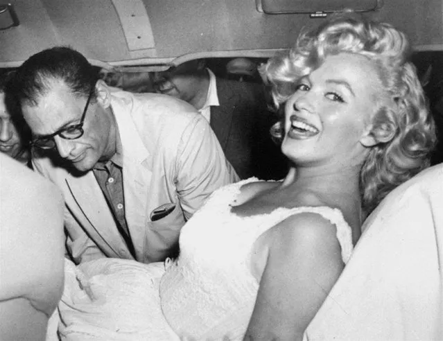 Marilyn Monroe is made comfortable in a car by her husband, playwright Arthur Miller, following her release from Doctors Hospital, New York City, August 10, 1957.  Marilyn was hospitalized for a miscarriage and spent 10 days in the hospital. (Photo by AP Photo)