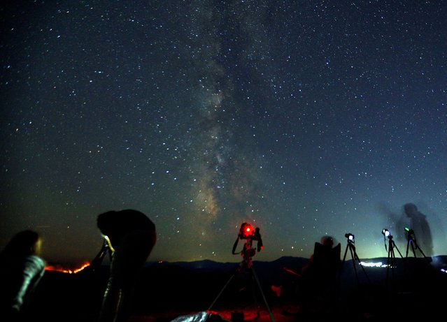 Astronomers observe the northern skies during the Perseid meteor shower in Kozjak, North Macedonia on August 12, 2024. (Photo by Ognen Teofilovski/Reuters)