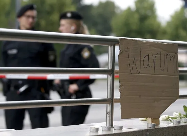 A sign reading “Why?” is placed on on a wall near the Olympia shopping mall, where yesterday's shooting rampage started, in Munich, Germany July 23, 2016. (Photo by Michael Dalder/Reuters)