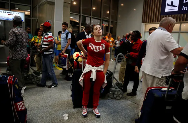 A member of Russia's Olympic team stands with her belongings during the team's arrival in the airport in Rio de Janeiro, Brazil, July 24, 2016. (Photo by Pilar Olivares/Reuters)