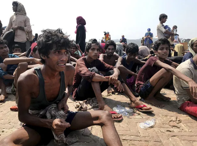 Rohingya refugees react after being rescued in Teknaf near Cox's Bazar, Bangladesh, Thursday, April 16, 2020. Bangladesh's coast guard has rescued 382 starving Rohingya refugees who had been drifting at sea for weeks after failing to reach Malaysia, officials said Thursday. (Photo by Suzauddin Rubel/AP Photo)