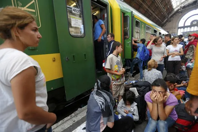 Migrants wait outside a train at the Keleti train station in Budapest, Hungary, September 3, 2015 as Hungarian police withdrew from the gates after two days of blocking their entry. (Photo by Laszlo Balogh/Reuters)