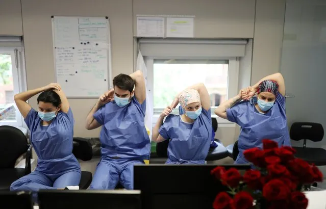 Hospital staff do yoga stretches and breathing exercises in the Intensive Care Unit (ICU) at the Hospital Clinic in Barcelona as the spread of the coronavirus disease (COVID-19) continues, Spain, April 23, 2020. (Photo by Nacho Doce/Reuters)