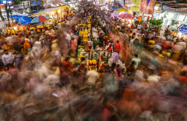 Indian people go shopping at a market ahead of the Ganesh Chaturthi festival in Mumbai, India, 30 August 2022. The forthcoming Ganesha Chaturthi is a ten-day long event which is celebrated all over India. During the Ganpati festival, that is celebrated as the birthday of Lord Ganesha, idols of the Hindu deity are worshipped at hundreds of pandals or makeshift tents before they are immersed into water bodies. This year, the festival starts on 31 August 2022. (Photo by Divyakant Solanki//EPA/EFE/Rex Features/Shutterstock)