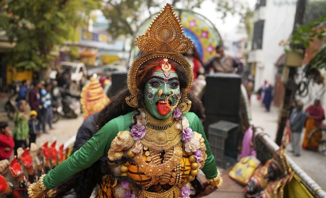 An Indian man dressed as Hindu goddess Kali dances during Shri Anand Akhara Panchayati in a procession towards the Sangam, the confluence of rivers Ganges and Yamuna, during the first '“oyal entry” (Peshwai) for the Mahakumbh festival, lasting 55 days and celebrated every 12 years in Prayagraj, in the northern Indian state of Uttar Pradesh, India, Monday, January 6, 2025. (Photo by Rajesh Kumar Singh/AP Photo)