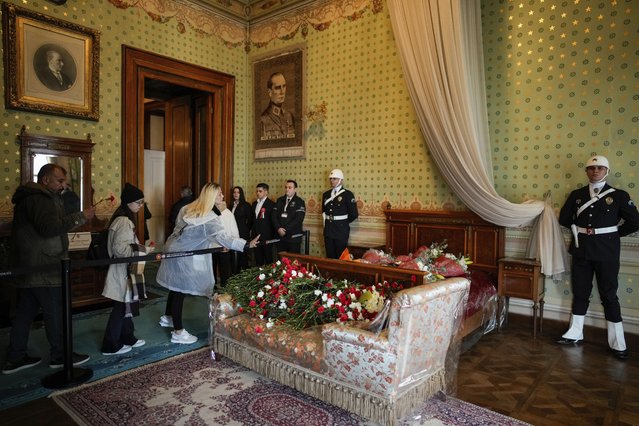 People place red carnations to pay tribute to Turkey's founding father Mustafa Kemal Ataturk during the 86th anniversary of his death at Dolmabahce palace in Istanbul, Turkey, Sunday, November 10, 2024. (Photo by Emrah Gurel/AP Photo)