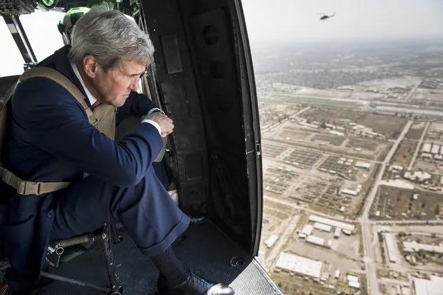 U.S. Secretary of State John Kerry looks out over Baghdad from a helicopter September 10, 2014. Kerry arrived in Baghdad on Wednesday as he began a tour of the Middle East to build military, political and financial support to defeat Islamic State militants controlling parts of Iraq and Syria. (Photo by Brendan Smialowski/Reuters)