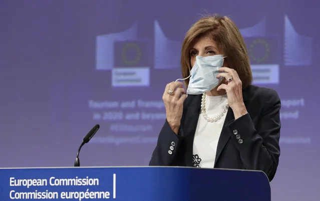 European Commissioner for Health Stella Kyriakides removes a mouth mask after addressing a media conference regarding tourism at EU headquarters in Brussels, Wednesday, May 13, 2020. The European Union unveiled Wednesday its plan to help citizens across the 27 nations salvage their summer vacations after months of coronavirus lockdown, and to resurrect Europe's badly battered tourism industry. (Photo by Olivier Hoslet/Pool Photo via AP Photo)