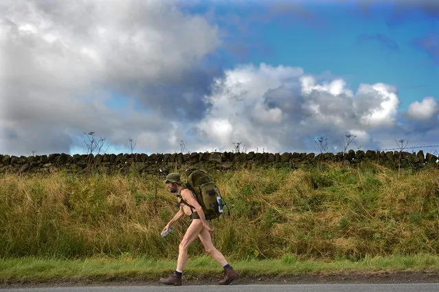 Stephen Gough the naked rambler makes his way south through Peebles in the Scottish Borders, following his release from Saughton Prison yesterday after serving his latest sentence on October 6, 2012 in Peebles, Scotland. The rambler has 18 convictions and has been in prison on and off since 2006 with offences ranging from not wearing clothes in front of the sheriff, breach of the peace and contempt of court. (Photo by Jeff J. Mitchell)