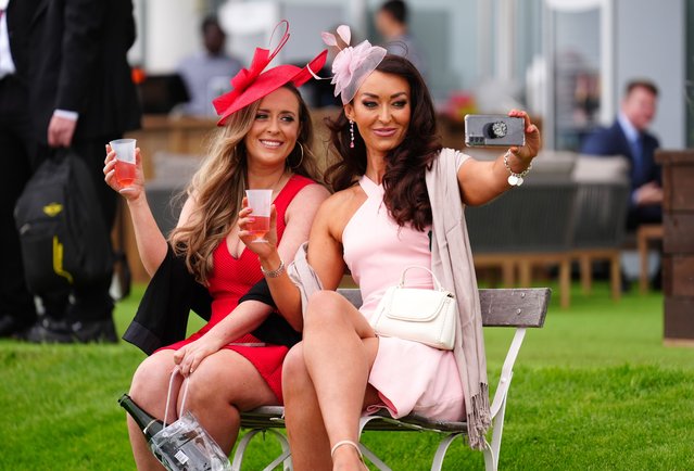 Racegoers pose for a selfie on ladies day of The Betfred Derby Festival at Epsom Downs Racecourse, UK on Friday, May 31, 2024. (Photo by Mike Egerton/PA Images via Getty Images)