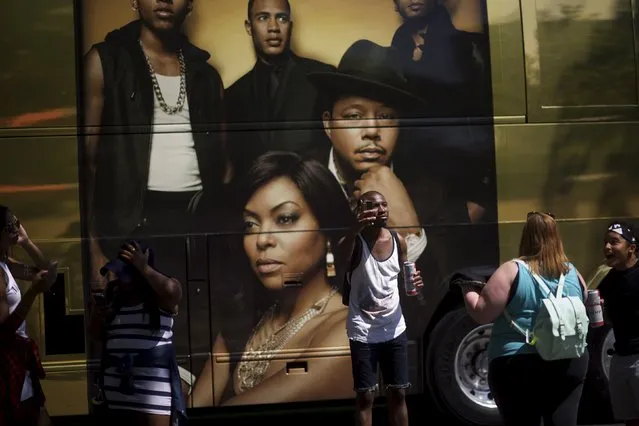 Attendees pose for pictures in front of a bus for FOX television show “Empire” during the fourth annual Made in America Music Festival in Philadelphia, Pennsylvania September 5, 2015. (Photo by Mark Makela/Reuters)