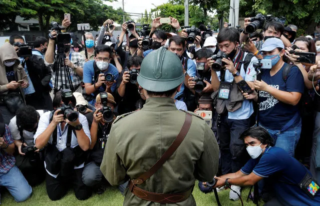 Members of the media take a photo of a protester dressed in a vintage uniform during a demonstration to demand for change in the constitution on the 88th anniversary of a revolt that ended absolute monarchy in the country, in front of parliament building in Bangkok, Thailand, June 24, 2020. (Photo by Jorge Silva/Reuters)