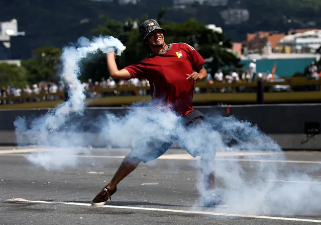 A protester clashes with the police during a rally to demand a referendum to remove Venezuela's President Nicolas Maduro in Caracas, Venezuela, September 1, 2016. (Photo by Carlos Garcia Rawlins/Reuters)
