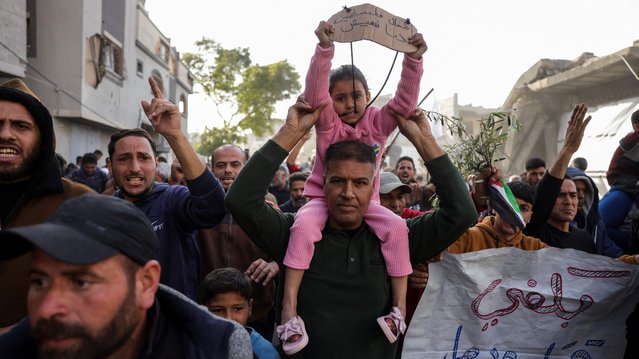 A slogan in Arabic reading (R): “Enough killing and destruction” and another reading (L): “The children of Palestine: We want to live” are displayed during a rally calling for an end to the war, in Beit Lahia, in the northern Gaza Strip, on March 25, 2025. Hundreds of Palestinians chanted anti-Hamas slogans at a protest in northern Gaza on March 25, calling for an end to the war with Israel, witnesses said. (Photo by AFP Photo)