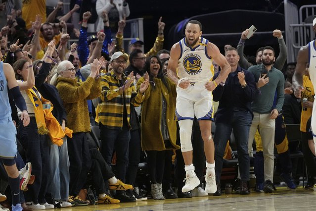 Fans react as Golden State Warriors guard Stephen Curry (30) celebrates after making a 3-point basket during the second half of an NBA play-in tournament basketball game against the Memphis Grizzlies in San Francisco, Tuesday, April 15, 2025. (Photo by Jeff Chiu/AP Photo)