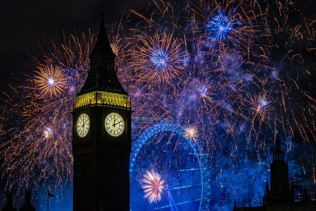 Fireworks light up the sky over the London Eye and the Elizabeth Tower (Big Ben) in central London during the New Year celebrations on Sunday, January 1, 2023. (Photo by Aaron Chown/PA Wire)
