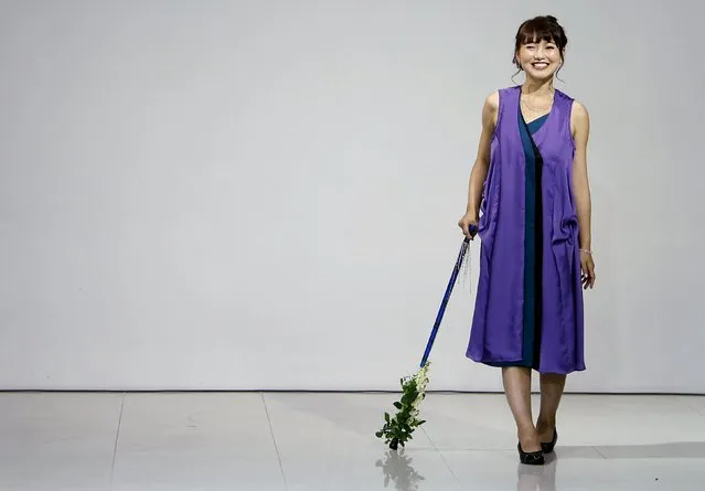 A model, a muscular dystrophy patient, walking with a cane, presents a creation by designer Takafumi Tsuruta from his Spring/Summer 2016 collection for his brand tenbo during Tokyo Fashion Week in Tokyo, Japan, October 13, 2015. (Photo by Yuya Shino/Reuters)