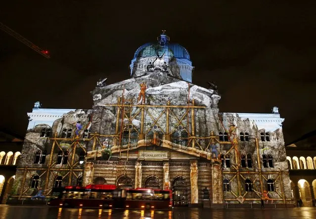 The Swiss Federal Palace (Bundeshaus) is illuminated by giant light projection "The Jewel of the Mountains" in Bern, Switzerland October 15, 2015. (Photo by Ruben Sprich/Reuters)
