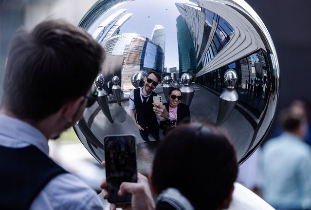 A couple takes a selfie as they reflect in the art installation at Moscow International Business Center, also known as Moscow-City, in Moscow, Russia, on June 2, 2025. (Photo by Maxim Shemetov/Reuters)
