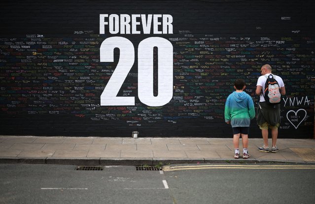 Fans look at messages written onto a memorial wall created near Anfield Stadium following the death of Liverpool soccer player Diogo Jota in Liverpool, Britain, on July 9, 2025. (Photo by Phil Noble/Reuters)