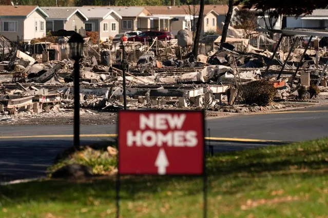 A sign advertising new homes stands in a neighborhood severely damaged by wildfire in Medford, Oregon, U.S. September 20, 2020. (Photo by David Ryder/Reuters)