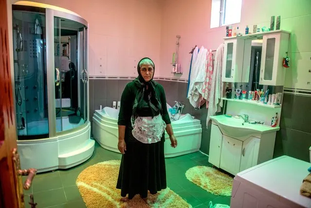 Romania. Ghita, 48, from Buzescu village, says she is the proud owner of one of the biggest bathrooms in the village. It is 20 square meters. 35% of the population of Buzescu village are Romas who are prosperous and proud to show it off. However, there is no running water or sewerage in the village so toilets are on-site. (Photo by Petrut Calinescu/WSUP/Panos)