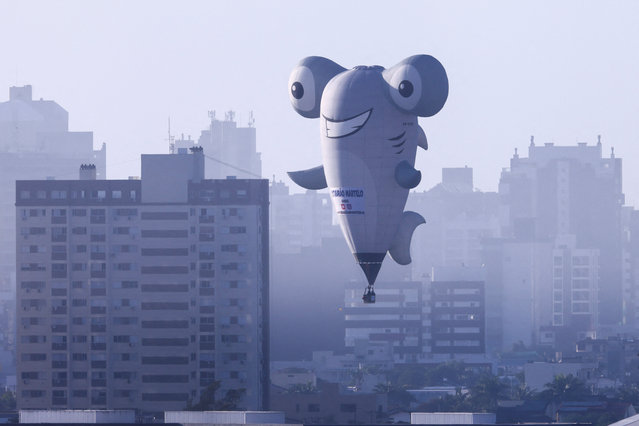 Balloonists take off during a competition at the 35th Balloon Festival in Torres, Rio Grande do Sul, Brazil on May 3, 2025. (Photo by Diego Vara/Reuters)
