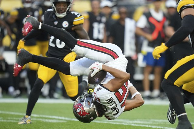 Tampa Bay Buccaneers wide receiver Jalen McMillan is upended by Pittsburgh Steelers cornerback Daryl Porter Jr. after catching a pass from quarterback Teddy Bridgewater during the first half of a preseason NFL football game, Saturday, August 16, 2025, in Pittsburgh. (Photo by Sue Ogrocki/AP Photo)