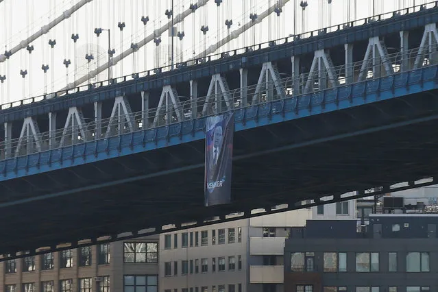 A banner with an image of Russian President Vladimir Putin hangs from the Manhattan Bridge in New York City, U.S., October 6, 2016. (Photo by Brendan McDermid/Reuters)