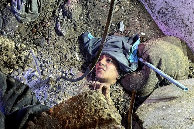 Palestinian woman Saja Hamad lies trapped under the rubble of a house hit in an Israeli strike, in Nuseirat in the central Gaza Strip on August 20, 2025. (Photo by Reuters/Stringer)