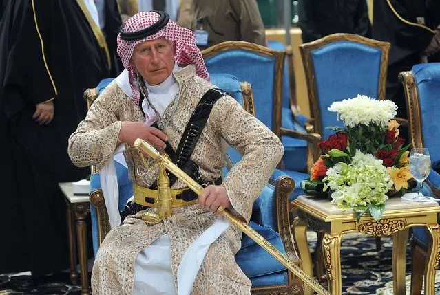 Britain's Prince Charles, wearing traditional Saudi attire, attends a traditional Saudi dance, known as “Arda”, which was performed during the Janadriya cultural festival at Der'iya in Riyadh, in this February 18, 2014 file photo. (Photo by Fayez Nureldine/Reuters)