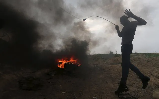 A Palestinian protester uses sling to hurl stones at Israeli troops during clashes near border between Israel and Central Gaza Strip November 6, 2015. (Photo by Ibraheem Abu Mustafa/Reuters)