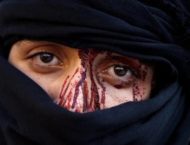 An Iraqi Shiite Muslim man is seen after flagellating himself in commemorations on the tenth day of the mourning period of Muharram, which marks the day of Ashura, in the holy city of Najaf on October 12, 2016. (Photo by Haidar Hamdani/AFP Photo)