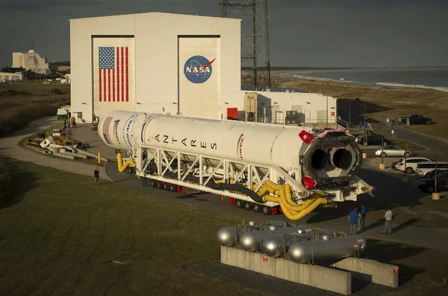 This image provided by NASA shows the Orbital ATK Antares rocket is rolled to launch pad Thursday, October 13, 2016 at NASA's Wallops Flight Facility in Wallops Island, Va. Orbital ATK's sixth contracted cargo resupply mission with NASA to the International Space Station will deliver over 5,100 pounds of science and research, crew supplies and vehicle hardware to the orbital laboratory and its crew. The launch of the rocket is scheduled for Sunday Oct. 16. (Photo by Bill Ingalls/NASA via AP Photo)