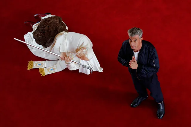 Italian artist Maurizio Cattelan poses with his creation “La Nona Ora” (The Ninth Hour, 1999) prior to the opening of the exhibition “Not Afraid of Love” at the Hotel de la Monnaie in Paris, France, October 17, 2016. (Photo by Philippe Wojazer/Reuters)
