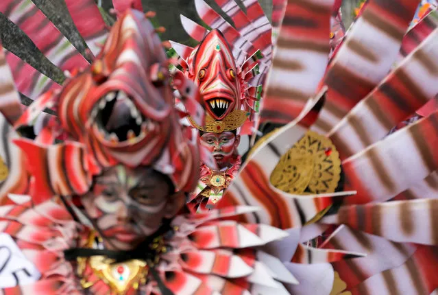 Balinese artists dressed in decorative costumes take part in the Maritime Festival at Pandawa Beach on the resort island of Bali, Indonesia May 9, 2018. (Photo by Johannes P. Christo/Reuters)