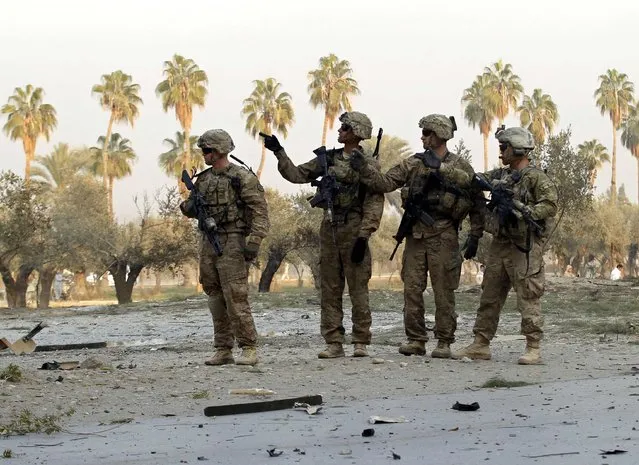 U.S. troops keep watch at the site of a suicide attack on the outskirts of Jalalabad, January 5, 2015. (Photo by Reuters/Parwiz)