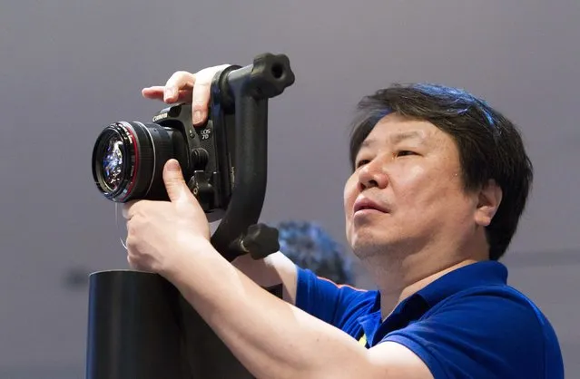 Kim Kyu-sung of South Korea holds a Canon 7D Mark II digital camera during the 2015 International Consumer Electronics Show (CES) in Las Vegas, Nevada January 6, 2015. (Photo by Steve Marcus/Reuters)