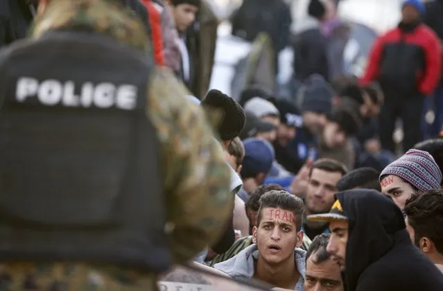 Migrants wait to cross the border from Greece into Macedonia, near Gevgelija, Macedonia November 24, 2015. Countries along the Balkan route taken by hundreds of thousands of migrants seeking refuge in western Europe last week began filtering the flow, granting passage only to those fleeing conflict in Syria, Iraq and Afghanistan. (Photo by Stoyan Nenov/Reuters)