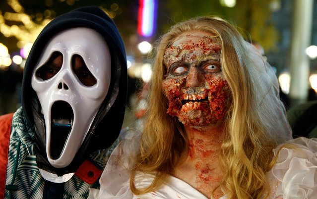 Zombie bride Fenia Luepkes from the western German city of Bochum poses for a selfie during the so-called “Zombie walk” through the western German city of Essen on Halloween Day, October 31, 2016. (Photo by Wolfgang Rattay/Reuters)